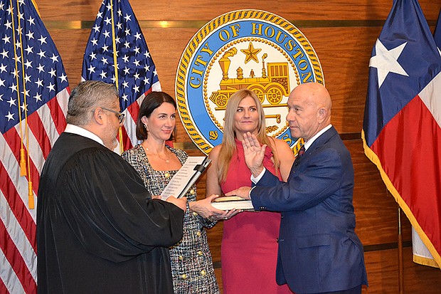 John Whitmire being sworn in as the City of Houston's 63rd mayor on January 1, 2024, by Harris County Justice of the Peace Victor Trevino, III, with daughters, Whitney Whitmire Jenkins and Sarah Whitmire.