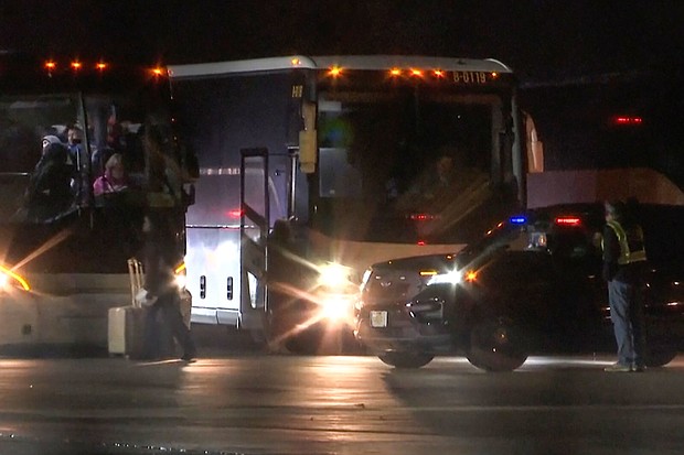 Migrants board buses around 1 a.m., Monday, at Chicago Rockford International Airport after arriving by plane from San Antonio, Texas.
Mandatory Credit:	WTVO NewsNation/AP