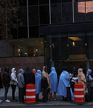 Immigrants stand waiting in line outside the Federal Plaza Immigration Court in New York City on November 6.
Mandatory Credit:	Shannon Stapleton/Reuters
