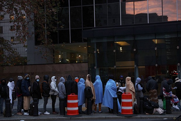 Immigrants stand waiting in line outside the Federal Plaza Immigration Court in New York City on November 6.
Mandatory Credit:	Shannon Stapleton/Reuters