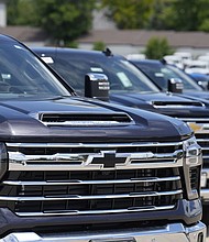 Silverado pickup trucks sit in a long row at a Chevrolet dealership in June. Fourth quarter sales of some GM vehicles, were hurt by the strike at the nation's three unionized automakers by the United Auto Workers union.
Mandatory Credit:	David Zalubowski/AP
