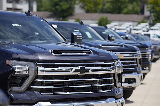 Silverado pickup trucks sit in a long row at a Chevrolet dealership in June. Fourth quarter sales of some GM vehicles, were hurt by the strike at the nation's three unionized automakers by the United Auto Workers union.
Mandatory Credit:	David Zalubowski/AP