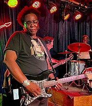 Corey Stoot on guitar with Scarface in the background/photo credit John Branch