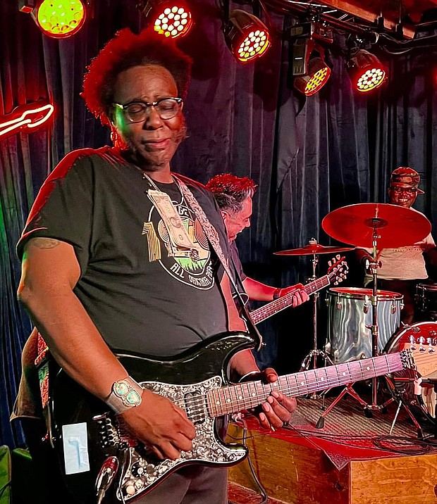 Corey Stoot on guitar with Scarface in the  background/photo credit John Branch