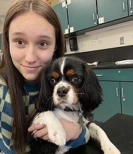 Alexis Hobson sits with Oxford in a classroom.
Mandatory Credit:	Courtesy Katie Hobson