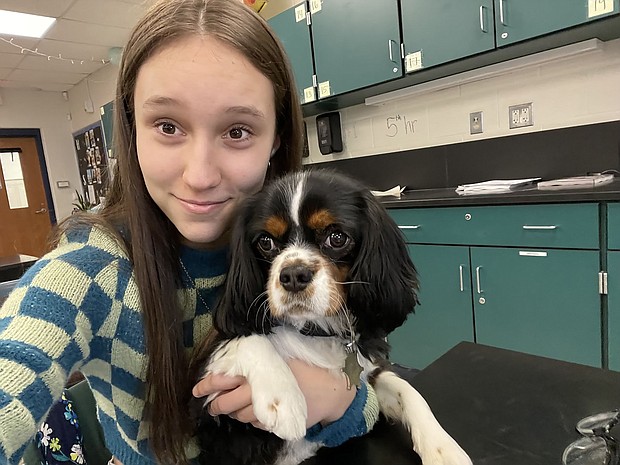 Alexis Hobson sits with Oxford in a classroom.
Mandatory Credit:	Courtesy Katie Hobson