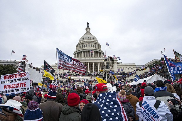 Rioters loyal to former President Donald Trump are seen here at the U.S. Capitol in Washington on January 6, 2021. Over 1,200 Americans have been charged criminally for their alleged actions during the riot.
Mandatory Credit:	Jose Luis Magana/AP