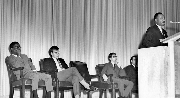 The people pictured behind Dr. King are (left to right): Bernard Lee, special assistant to Dr. King; Charles Cox, the chair of the Students' Association Academic Committee (now called the Student Senate); Bert Moore, vice president of the SMU Students' Association; and Sanford Coon, Perkins School of Theology student.