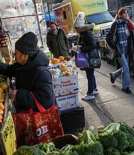 Patrons shop for produce at a Mr. Pina Market in Brooklyn, New York, on December 26. The US inflation picture greatly improved in 2023, and so have Americans’ attitudes about it.
Mandatory Credit:	Victor J. Blue/Bloomberg/Getty Images