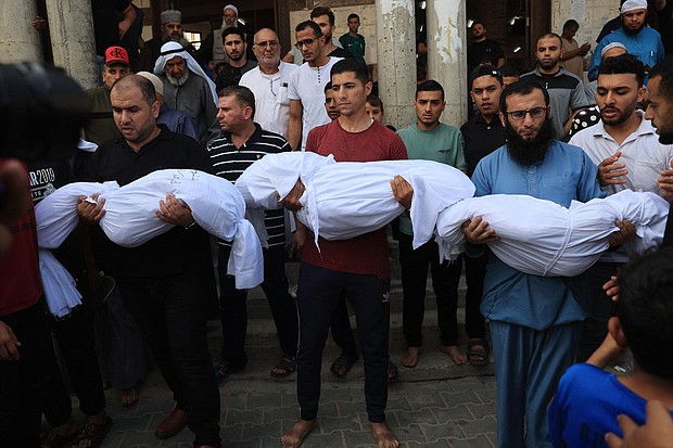 Relatives carry the bodies of children from the Abu Quta family who were killed in Israeli strikes on the Palestinian city of Rafah in the southern Gaza Strip, during their funeral in October 2023.
Mandatory Credit:	Said Khatib/AFP/Getty Images