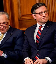 Senate Majority Leader Chuck Schumer and House Speaker Mike Johnson listen at the US Capitol on December 12, in Washington, DC.
Mandatory Credit:	Anna Moneymaker/Getty Images