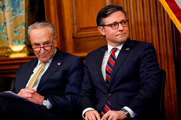 Senate Majority Leader Chuck Schumer and House Speaker Mike Johnson listen at the US Capitol on December 12, in Washington, DC.
Mandatory Credit:	Anna Moneymaker/Getty Images