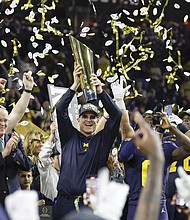 Jim Harbaugh celebrates after winning the College Football Playoff National Championship game against the Washington Huskies.
Mandatory Credit:	Darren Lee/AP
