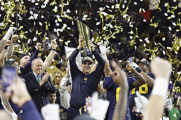 Jim Harbaugh celebrates after winning the College Football Playoff National Championship game against the Washington Huskies.
Mandatory Credit:	Darren Lee/AP