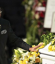 Kirk Johnson touches the casket of his mother, former U.S. Rep. Eddie Bernice Johnson, during her funeral service on Tuesday, Jan. 9.