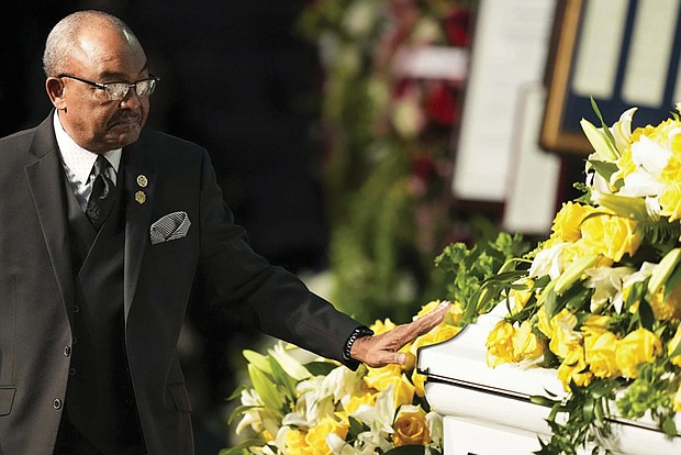 Kirk Johnson touches the casket of his mother, former U.S. Rep. Eddie Bernice Johnson, during her funeral service on Tuesday, Jan. 9.