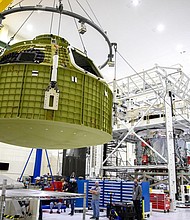 The Orion pressure vessel for NASA’s Artemis III mission is shown being lifted by crane for its move onto a work stand at NASA’s Kennedy Space Center in Florida in 2021.
Mandatory Credit:	Glenn Benson/NASA