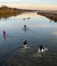 Immigrants wade across the Rio Grande while crossing Sunday from Mexico to Eagle Pass, Texas.
Mandatory Credit:	John Moore/Getty Images