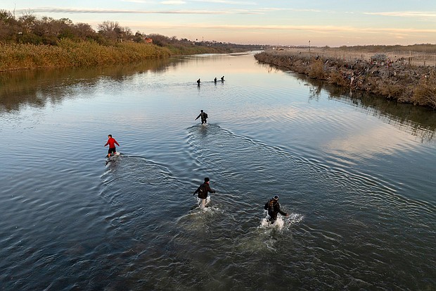 Immigrants wade across the Rio Grande while crossing Sunday from Mexico to Eagle Pass, Texas.
Mandatory Credit:	John Moore/Getty Images
