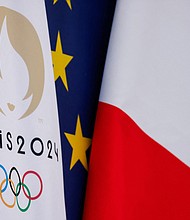 This Paris 2024 Olympic Games flag next to European Union and French flag at the presidential Elysee Palace in Paris in 2024.
Mandatory Credit:	Ludovic Marin/AFP/Getty Images