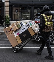 A UPS seasonal worker delivers packages in New York in November 2023.
Mandatory Credit:	Stephanie Keith/Bloomberg/Getty Images