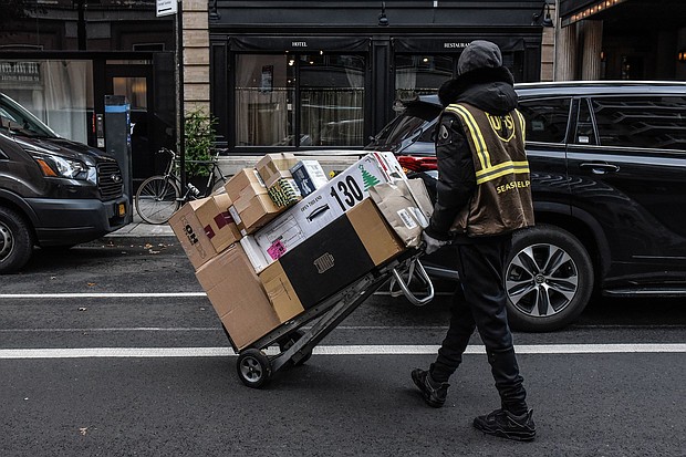 A UPS seasonal worker delivers packages in New York in November 2023.
Mandatory Credit:	Stephanie Keith/Bloomberg/Getty Images