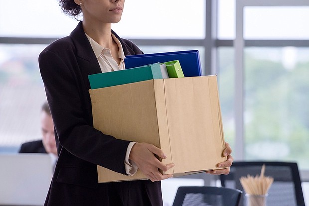 An unemployed worker with her cardboard box walking out of the office
Mandatory Credit:	Anchalee Phanmaha/Moment RF/Getty Images