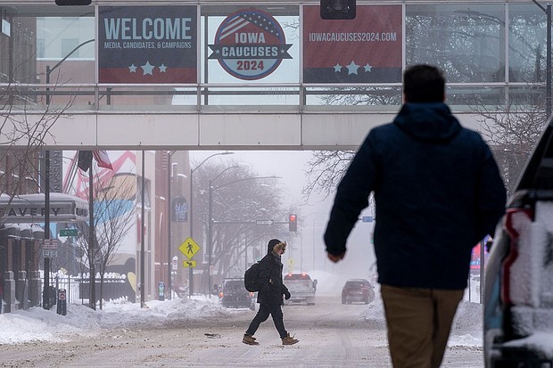 People walk across the street in downtown Des Moines on January 13. Iowa Republicans who are willing to brave record-low temperatures are set to kick off the party’s 2024 presidential nominating process with Monday night’s caucuses.
Mandatory Credit:	Andrew Harnik/AP