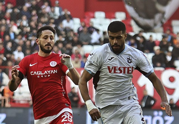 Jehezkel (left) vies with Trabzonspor's Rayyan Baniya for the ball during Sunday's game between Antalyaspor and Trabzonspor.
Mandatory Credit:	Cafer Eser/IHA/AP