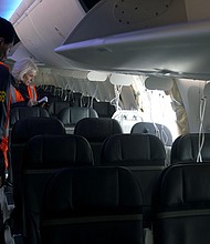 Members of the NTSB examine the hole in the fuselage plug area of Alaska Airlines Flight 1282 on a Boeing 737 Max 9.
Mandatory Credit:	NTSB/Handout/Getty Images