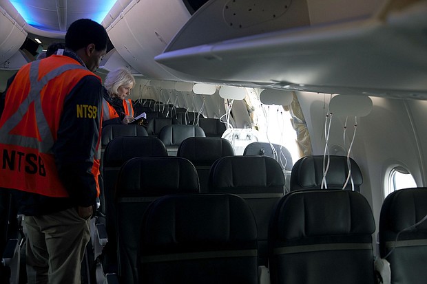 Members of the NTSB examine the hole in the fuselage plug area of Alaska Airlines Flight 1282 on a Boeing 737 Max 9.
Mandatory Credit:	NTSB/Handout/Getty Images