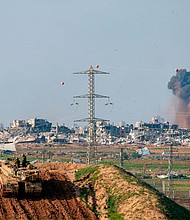 An Israeli tank takes position near the border with Gaza on January 16.
Mandatory Credit:	Menahem Kahana/AFP/Getty Images