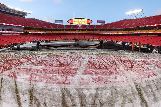 A view of the field at Arrowhead Stadium in Kansas City as the grounds crew removes the cover before the playoff game between the Chiefs and the Dolphins.
Mandatory Credit:	Scott Winters/Icon Sportswire/Getty Images