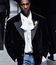 A golden brooch on the lapel of an updated tuxedo Dolce & Gabanna.
Mandatory Credit:	Victor Virgile/Gamma-Rapho/Getty Images