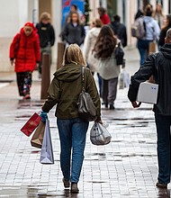 Shoppers carry bags in Walnut Creek, California, US, on Wednesday, Dec. 20, 2023. US retail sales unexpectedly picked up in November as lower gasoline prices allowed consumers to spend more to kick off the holiday shopping season.
Mandatory Credit:	David Paul Morris/Bloomberg/Getty Images