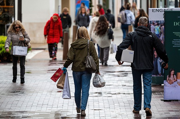 Shoppers carry bags in Walnut Creek, California, US, on Wednesday, Dec. 20, 2023. US retail sales unexpectedly picked up in November as lower gasoline prices allowed consumers to spend more to kick off the holiday shopping season.
Mandatory Credit:	David Paul Morris/Bloomberg/Getty Images