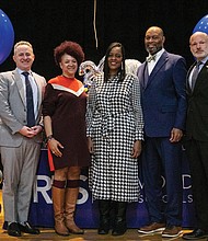Tranelle Pollard, middle, is congratulated by school officials for being named Richmond Public Schools’ 2024 Teacher of the Year. Standing with her are, from left, RPS Superintendent Jason Kamras, RPS School Board Chair Stephanie Rizzi, RPS Board member Jonathan Young, and Dogwood Middle School Principal Christopher Jacobs.