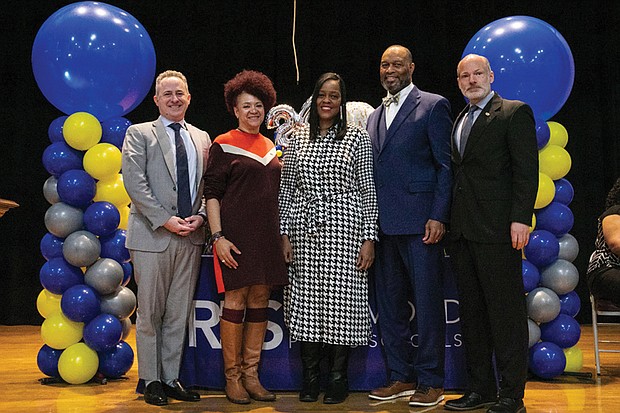 Tranelle Pollard, middle, is congratulated by school officials for being named Richmond Public Schools’ 2024 Teacher of the Year. Standing with her are, from left, RPS Superintendent Jason Kamras, RPS School Board Chair Stephanie Rizzi, RPS Board member Jonathan Young, and Dogwood Middle School Principal Christopher Jacobs.