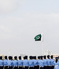 Members of the Pakistan Air Force (PAF) stand in formation during the national anthem, as a part of the Defence Day ceremonies, or Pakistan's Memorial Day, in Karachi, Pakistan September 6, 2021.
Mandatory Credit:	Akhtar Soomro/Reuters