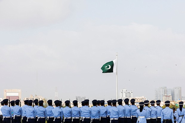 Members of the Pakistan Air Force (PAF) stand in formation during the national anthem, as a part of the Defence Day ceremonies, or Pakistan's Memorial Day, in Karachi, Pakistan September 6, 2021.
Mandatory Credit:	Akhtar Soomro/Reuters