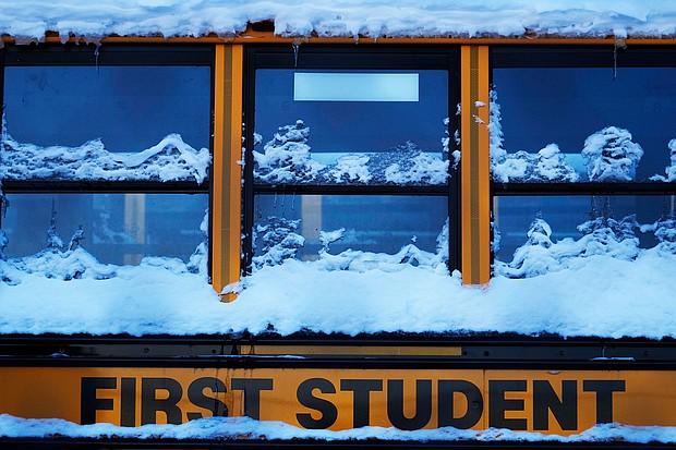 A snow covered school bus sits in a parking lot in Wheeling, Illinois, Tuesday, Jan. 16.
Mandatory Credit:	Nam Y. Huh/AP