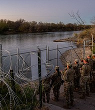 National Guard soldiers stand guard on the banks of the Rio Grande river at Shelby Park on January 12 in Eagle Pass, Texas. The Texas National Guard continued its blockade and surveillance of Shelby Park in an effort to deter illegal immigration.
Mandatory Credit:	Brandon Bell/Getty Images