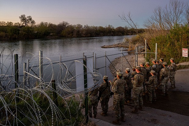 National Guard soldiers stand guard on the banks of the Rio Grande river at Shelby Park on January 12 in Eagle Pass, Texas. The Texas National Guard continued its blockade and surveillance of Shelby Park in an effort to deter illegal immigration.
Mandatory Credit:	Brandon Bell/Getty Images