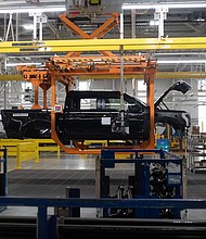 A Ford F-150 Lightning on a production line of the Ford Motor Co. Rouge Electric Vehicle Center (REVC) in Dearborn, Michigan on Sept. 8, 2022. Ford will shut down one of two production shifts in April at the Dearborn, Michigan, factory that builds the F-150 Lightning electric pickup.
Mandatory Credit:	Emily Elconin/Bloomberg/Getty Images