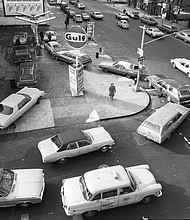 In this Dec. 23, 1973, file photo, cars line up in two directions at a gas station in New York City. Right-on-red was a gas-savings tool during the 1970s oil crisis.
Mandatory Credit:	Marty Lederhandler/AP