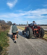 Holden Ringer walks by a tractor during his 10-month walk across America
Mandatory Credit:	Courtesy Holden Minor Ringer