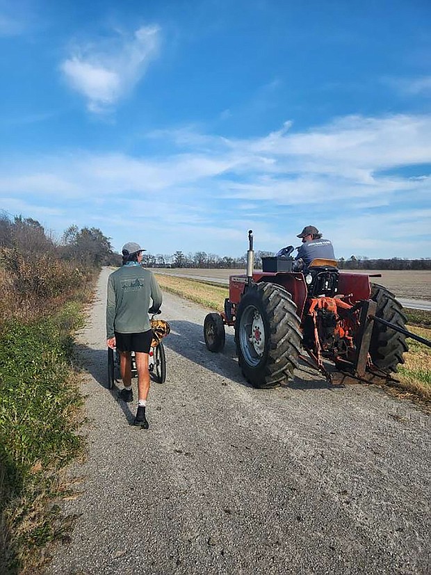 Holden Ringer walks by a tractor during his 10-month walk across America
Mandatory Credit:	Courtesy Holden Minor Ringer