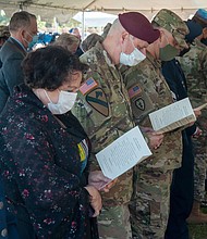 Military and civilian personnel bow their heads during the Port Tampa Cemetery Service of Remembrance at the MacDill Air Force Base on February 23, 2021.
Mandatory Credit:	Airman 1st Class David McLoney/US Air Force