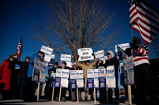 Attendees hold signs during a Write-In Joe Biden campaign "Get Out The Vote" event in Dover, New Hampshire, on January 21. A robocall that appears to be an AI voice resembling Biden is reaching out to New Hampshire residents.
Mandatory Credit:	Al Drago/Bloomberg/Getty Images