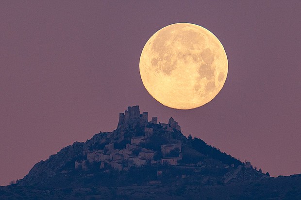 The wolf moon can be seen setting behind the castle of Rocca Calascio in the Abruzzo region of Italy, on January 7, 2023.
Mandatory Credit:	Lorenzo Di Cola/NurPhoto/Getty Images